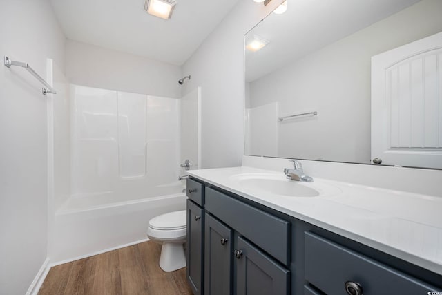 full bathroom featuring hardwood / wood-style flooring, vanity, toilet, and bathtub / shower combination