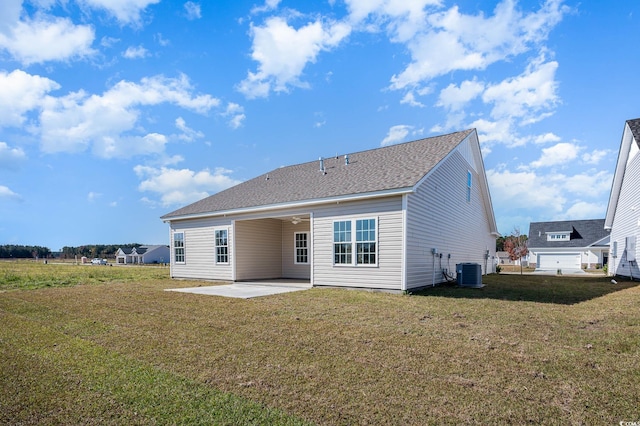 back of house featuring central AC unit, a lawn, and a patio