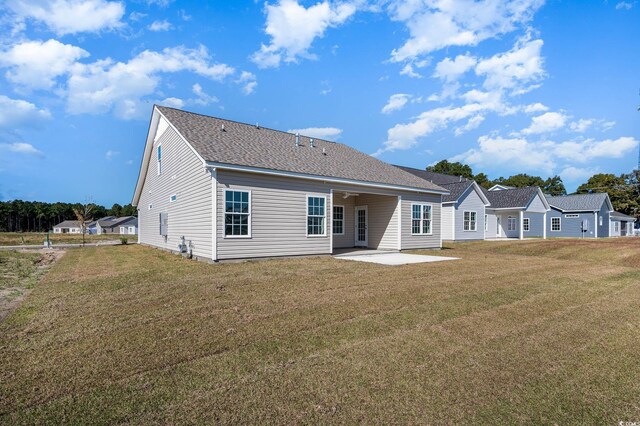 back of house featuring a yard and a patio area