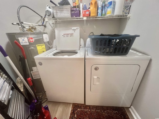laundry area with independent washer and dryer, water heater, and wood finished floors