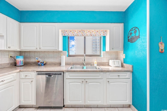 kitchen with dishwasher, decorative backsplash, white cabinetry, and sink