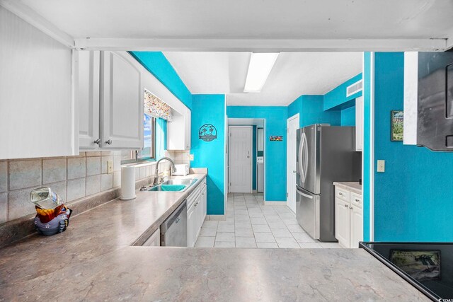 kitchen featuring white cabinetry, sink, and appliances with stainless steel finishes