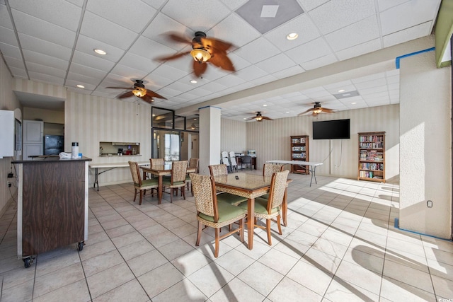 tiled dining room featuring a paneled ceiling and ceiling fan