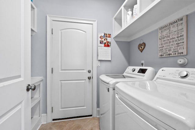 clothes washing area featuring light tile patterned floors and independent washer and dryer