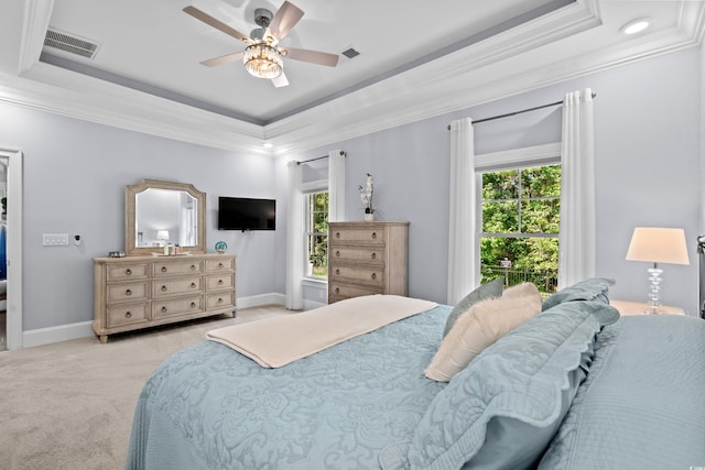 bedroom featuring ornamental molding, ceiling fan, and a raised ceiling