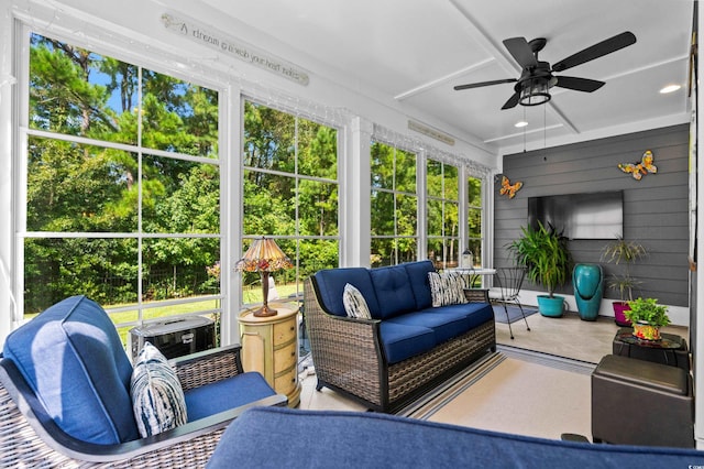 sunroom / solarium featuring ceiling fan