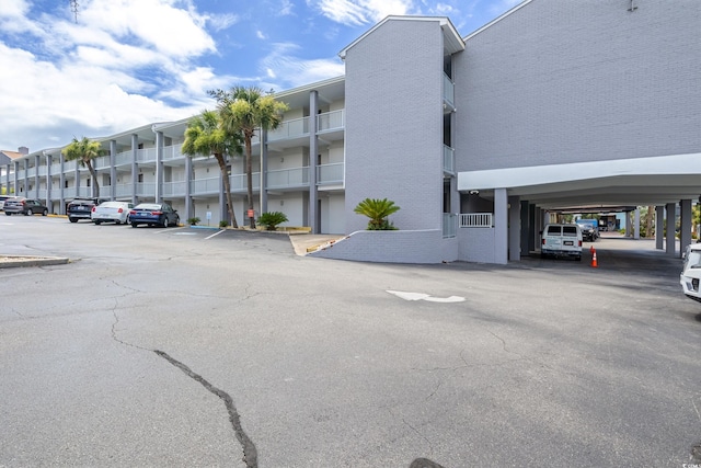 view of building exterior featuring uncovered parking