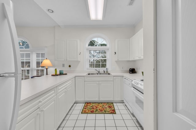 kitchen with white cabinetry, white appliances, sink, and light tile patterned floors