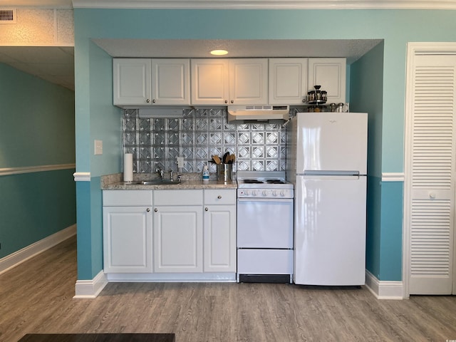 kitchen with white cabinets, white appliances, light hardwood / wood-style floors, and sink