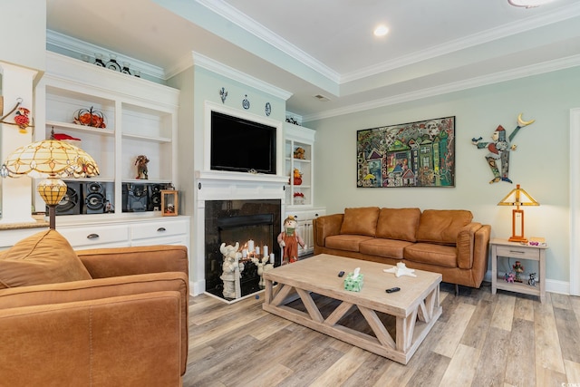 living room with hardwood / wood-style flooring and crown molding