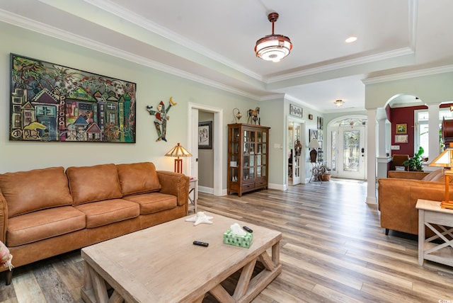 living room with ornamental molding, wood-type flooring, and decorative columns