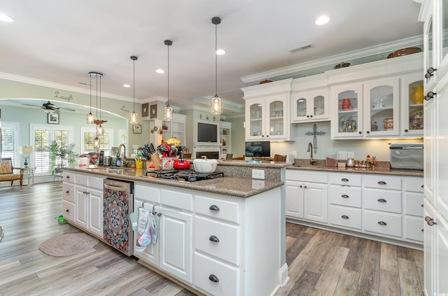 kitchen featuring white cabinetry, ornamental molding, ceiling fan, and decorative light fixtures