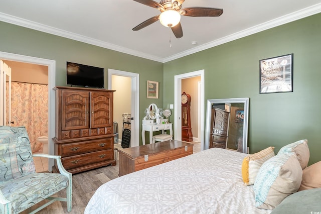 bedroom featuring ensuite bathroom, light hardwood / wood-style floors, ceiling fan, and crown molding