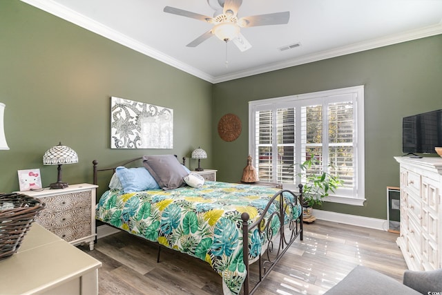 bedroom with wood-type flooring, ceiling fan, and crown molding