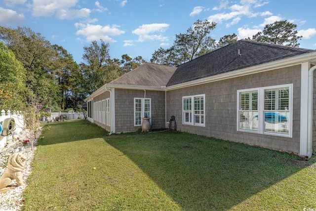 rear view of property with a lawn