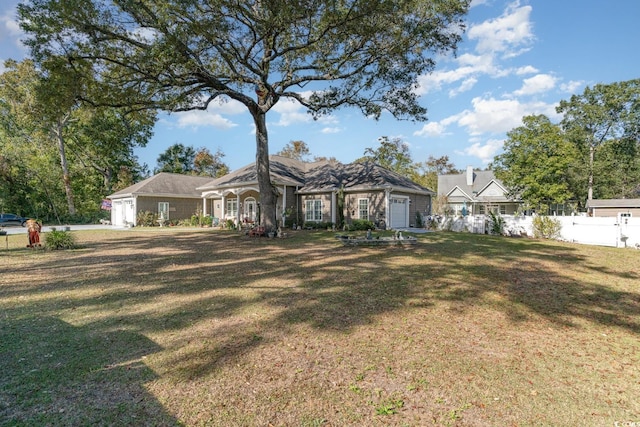 single story home with a front lawn and a garage