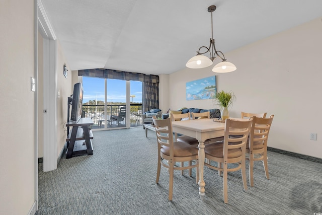 carpeted dining room with lofted ceiling