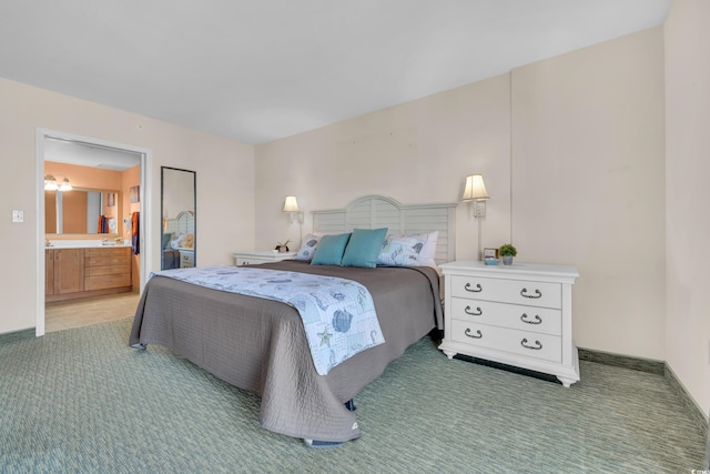 bedroom featuring light colored carpet and ensuite bath