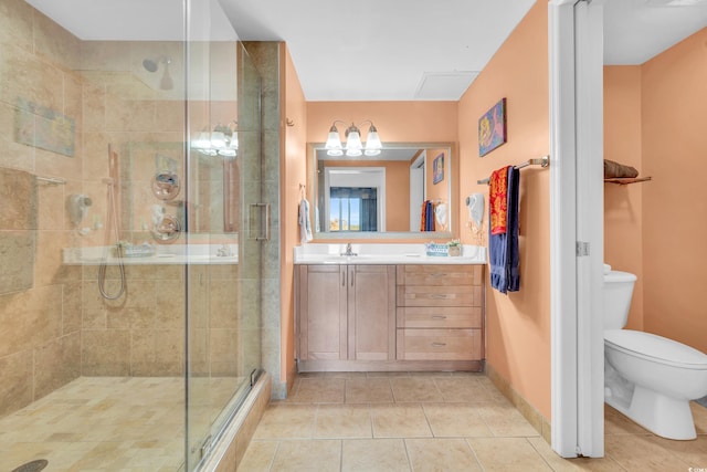 bathroom with vanity, tile patterned flooring, toilet, and an enclosed shower