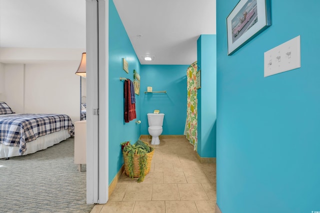 hall with light tile patterned floors