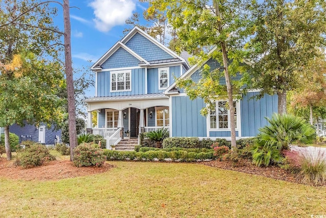 craftsman house with a porch and a front lawn