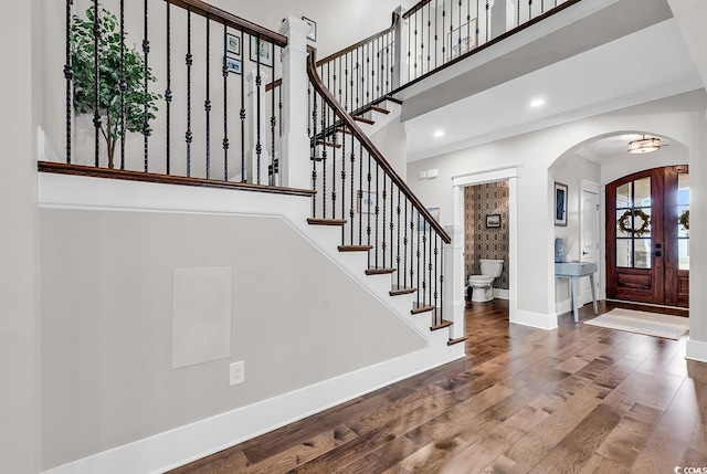 entryway with hardwood / wood-style floors and crown molding