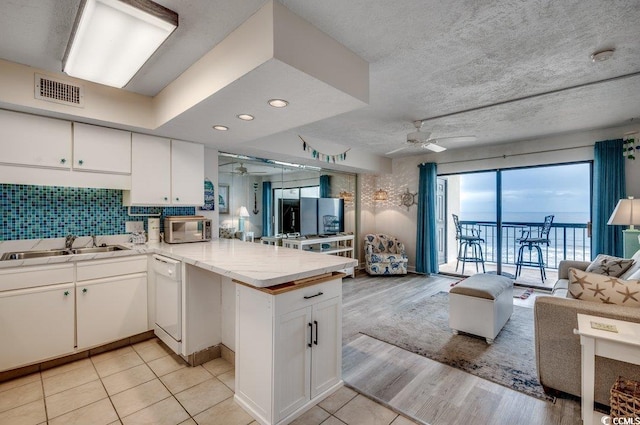 2609 S Ocean Blvd Unit 403, North Myrtle Beach, SC 29582 - kitchen with a ceiling fan, open floor plan, stainless steel microwave, a peninsula, and recessed lighting