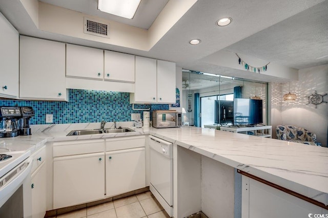 2609 S Ocean Blvd Unit 403, North Myrtle Beach, SC 29582 - kitchen featuring white appliances, a sink, white cabinets, decorative backsplash, and light tile patterned floors