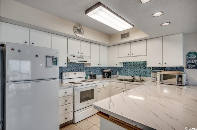 2609 S Ocean Blvd Unit 403, North Myrtle Beach, SC 29582 - kitchen with white appliances, under cabinet range hood, a sink, white cabinets, and recessed lighting