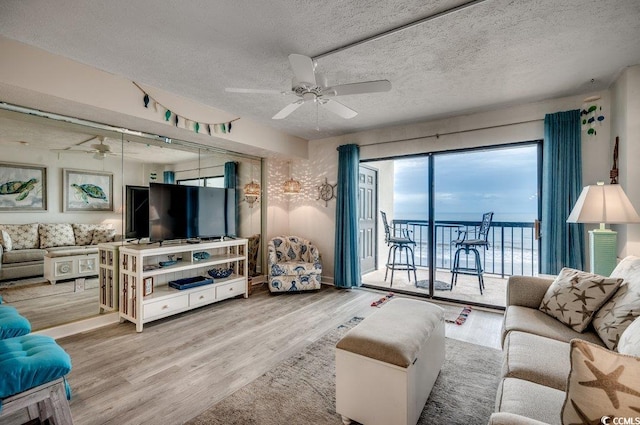 2609 S Ocean Blvd Unit 403, North Myrtle Beach, SC 29582 - living room featuring a ceiling fan, wood finished floors, and a textured ceiling