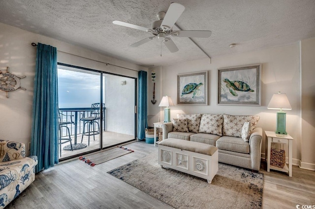 2609 S Ocean Blvd Unit 403, North Myrtle Beach, SC 29582 - living area with a textured ceiling, wood finished floors, and a ceiling fan