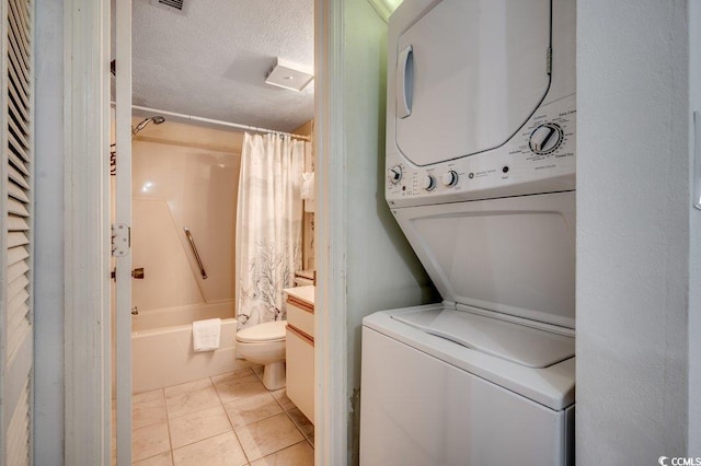 2609 S Ocean Blvd Unit 403, North Myrtle Beach, SC 29582 - laundry room featuring stacked washer and clothes dryer and a textured ceiling