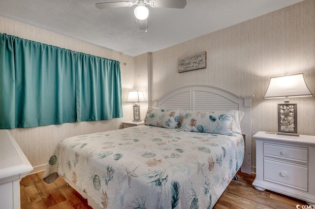 2609 S Ocean Blvd Unit 403, North Myrtle Beach, SC 29582 - bedroom with wood finished floors, a ceiling fan, and a textured ceiling
