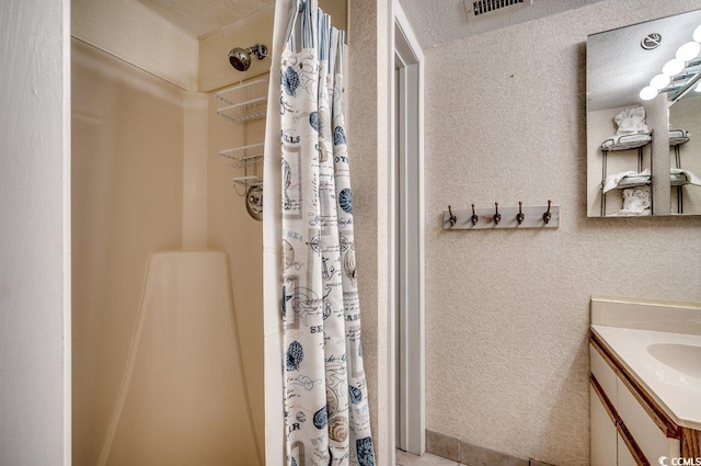 2609 S Ocean Blvd Unit 403, North Myrtle Beach, SC 29582 - full bathroom with a shower with curtain, vanity, and a textured wall