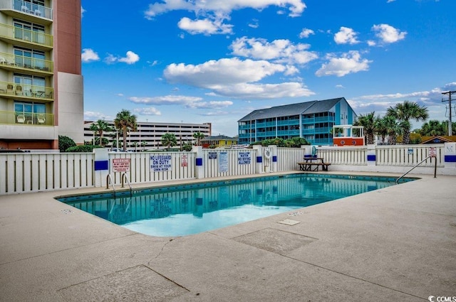 2609 S Ocean Blvd Unit 403, North Myrtle Beach, SC 29582 - community pool featuring fence and a patio area