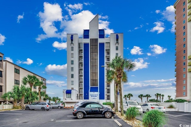 2609 S Ocean Blvd Unit 403, North Myrtle Beach, SC 29582 - view of property featuring uncovered parking and fence