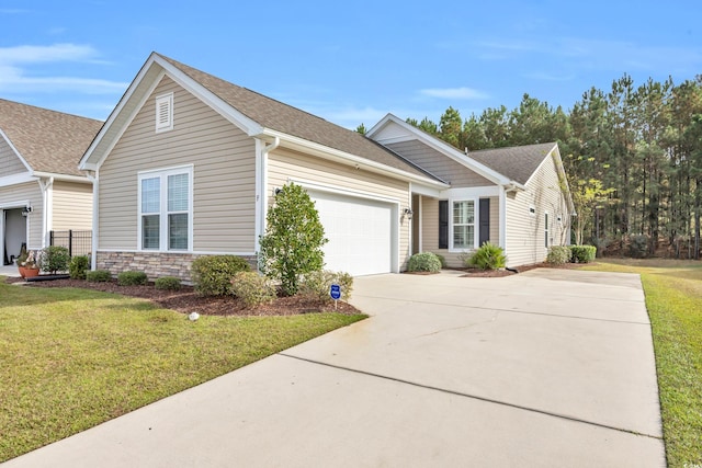 view of front of property with a front yard and a garage