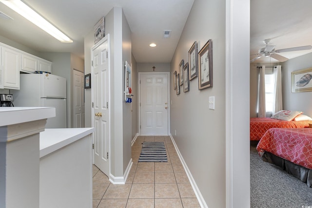 hallway featuring light tile patterned floors