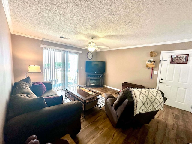 living room with hardwood / wood-style flooring, ceiling fan, a textured ceiling, and crown molding