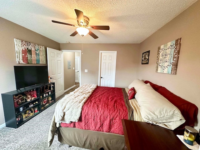 carpeted bedroom with a textured ceiling and ceiling fan