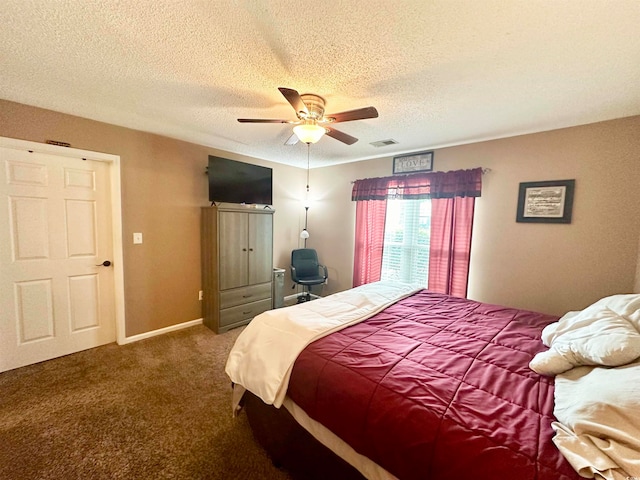 carpeted bedroom with ceiling fan and a textured ceiling