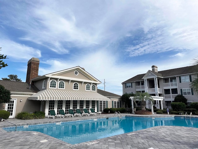 view of swimming pool with a patio