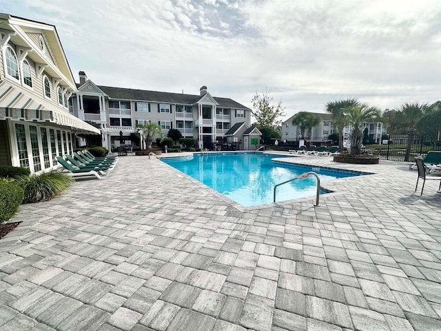 view of swimming pool with a patio