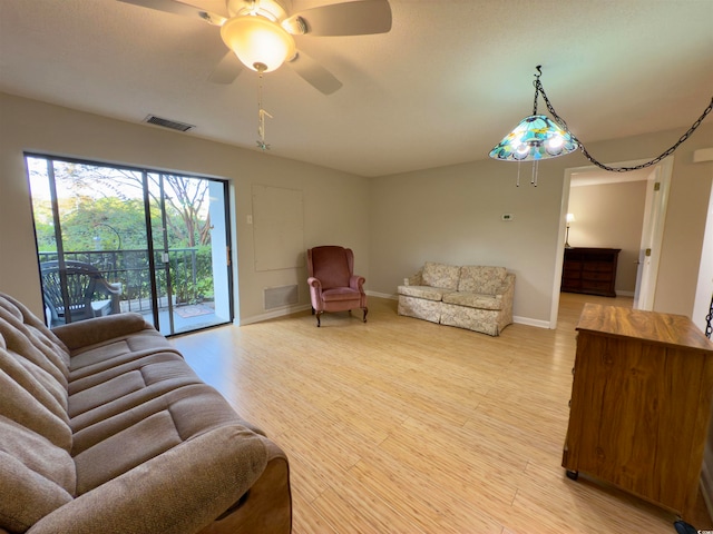 living room with light wood-type flooring and ceiling fan