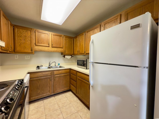 kitchen with sink, light tile patterned floors, and stainless steel appliances