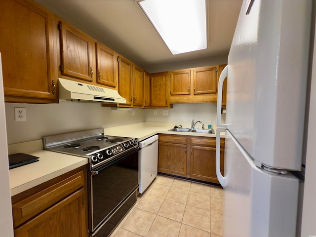 kitchen featuring sink, white appliances, and light tile patterned floors