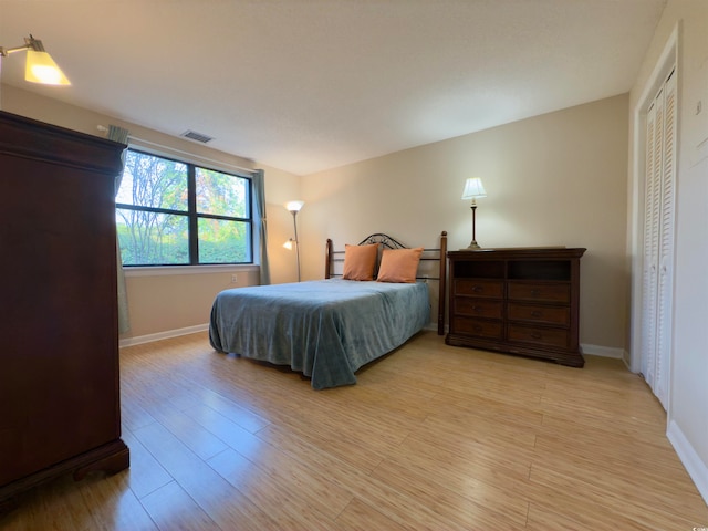 bedroom with a closet and light hardwood / wood-style floors