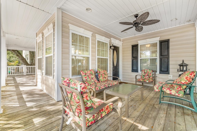 wooden deck with covered porch and ceiling fan