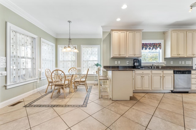 kitchen with cream cabinets, light tile patterned floors, stainless steel dishwasher, crown molding, and pendant lighting