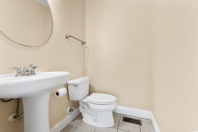 bathroom featuring tile patterned flooring, sink, and toilet